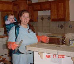 7-month-old Sara on my back while I grouted the kitchen tile of our new kitchen, March 17, 2002